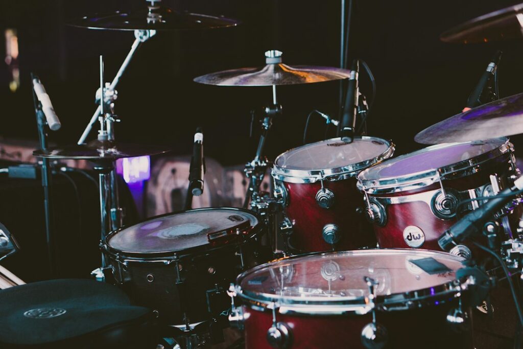 Red drum set in a recording space, representing the drum-break history discussed in the Funky Drummer article